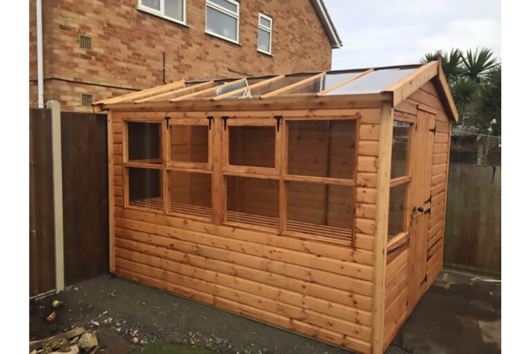 a wooden half glass potting shed with windows