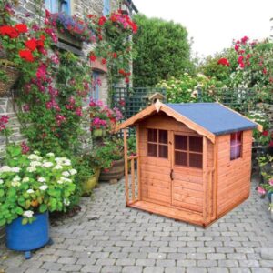 Explore our range of Wendy Houses & Play Sets a wooden playhouse in a garden