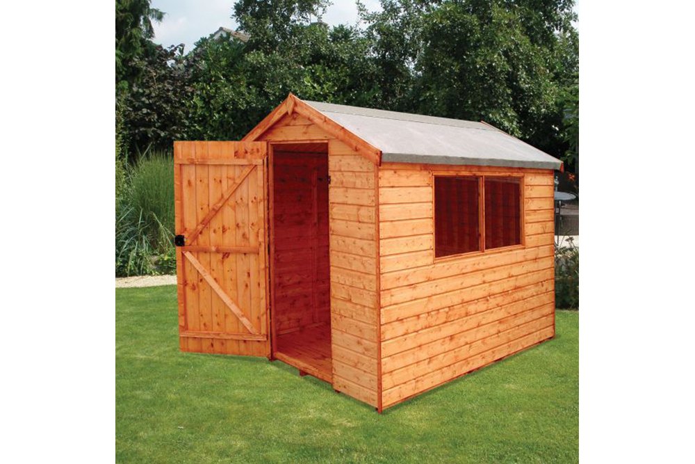 a wooden shed on a lawn