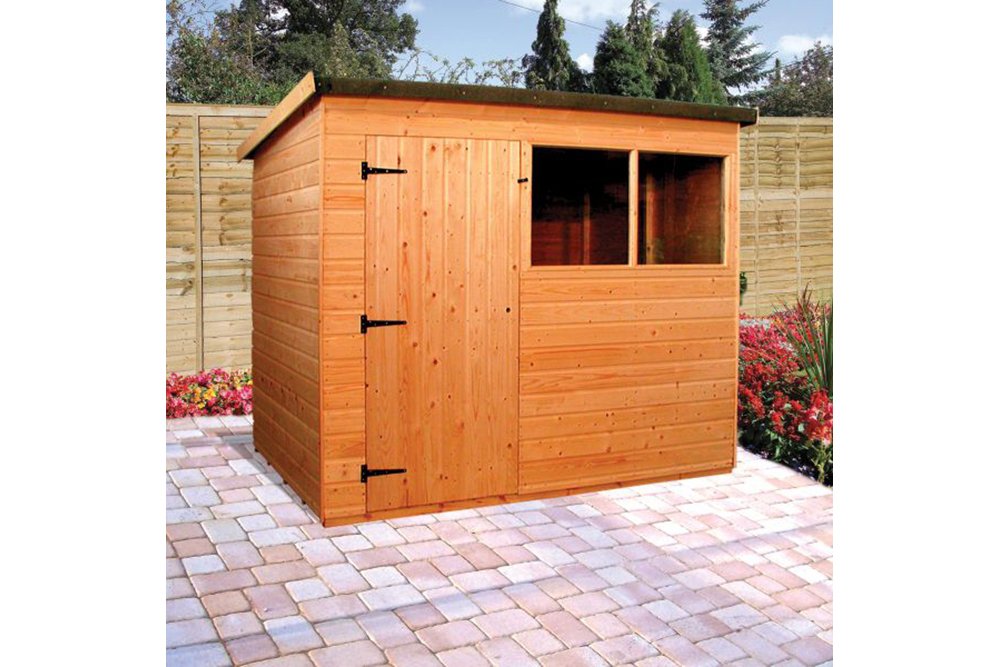 a wooden shed in a garden