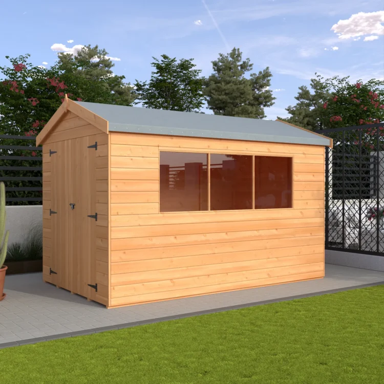 A small wooden shed with a grey roof and double doors on a patio in a garden with trees and a fence