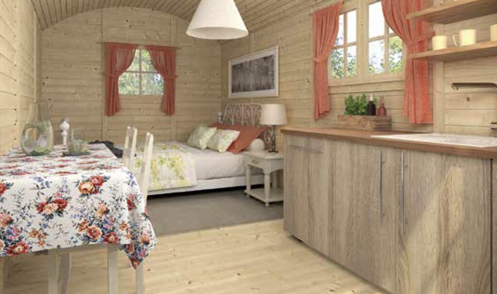 Cozy log cabin interior with floral tablecloth, wooden accents, and bed in background, warm colours, inviting atmosphere