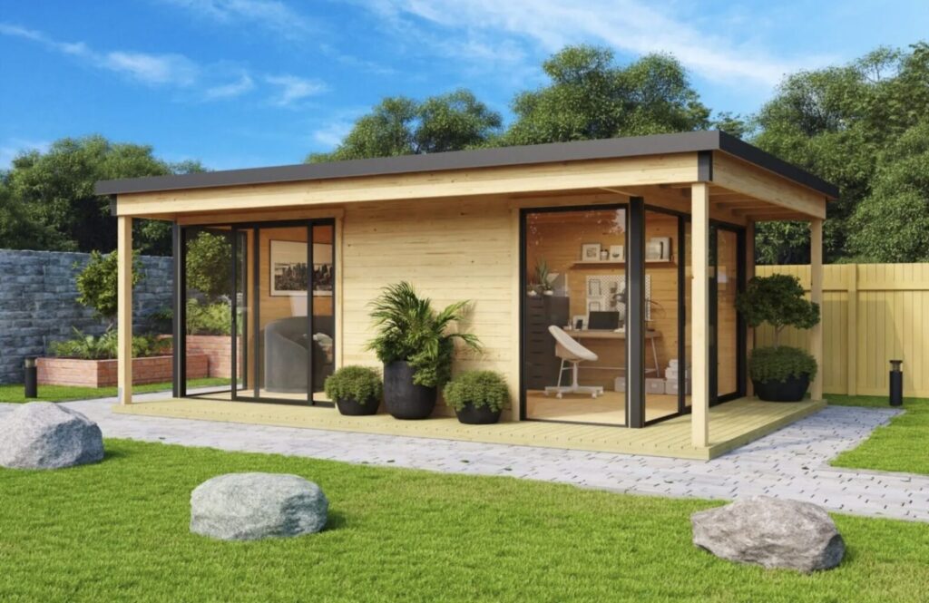 Multi-room timber cabin with black trim on cut green grass
